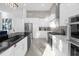 Modern kitchen with stainless steel appliances and white cabinetry at 2137 Pine Oak Loop, Davenport, FL 33837