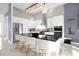 Modern kitchen with white cabinets, black countertops, and gold barstools at 2137 Pine Oak Loop, Davenport, FL 33837