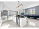 Open concept kitchen with island and stainless steel appliances at 2137 Pine Oak Loop, Davenport, FL 33837