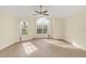 Spacious Primary bedroom with vaulted ceiling and large windows at 2317 Prime Cir # B, Kissimmee, FL 34746