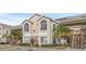 Two-story condo building with parking and tropical landscaping at 2317 Prime Cir # B, Kissimmee, FL 34746