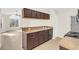 Open kitchen with breakfast bar and view to living room at 2317 Prime Cir # B, Kissimmee, FL 34746
