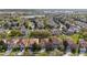 An aerial view of a community showcasing the neighborhood and its serene lake at 2615 Pawnall St, Kissimmee, FL 34747