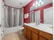 Bathroom featuring a tub with a black and white shower curtain and a vanity with wood cabinets at 2615 Pawnall St, Kissimmee, FL 34747
