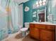 Bright, playful bathroom with a fairy-themed shower curtain, vanity, and a wall-mounted hair dryer at 2615 Pawnall St, Kissimmee, FL 34747