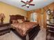 Well-furnished bedroom with a ceiling fan and natural light at 2615 Pawnall St, Kissimmee, FL 34747