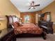 Comfortable bedroom features elegant dark wood furnishings and a ceiling fan at 2615 Pawnall St, Kissimmee, FL 34747