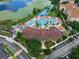 Aerial view of the community clubhouse, pool, and aquatic park by a lake at 2615 Pawnall St, Kissimmee, FL 34747