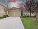 Charming two-story home with a well-manicured lawn and a two-car garage at 2615 Pawnall St, Kissimmee, FL 34747
