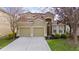 Charming two-story home with a well-manicured lawn and a two-car garage at 2615 Pawnall St, Kissimmee, FL 34747