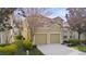 Side view of a two-story home with a well-manicured lawn and a two-car garage at 2615 Pawnall St, Kissimmee, FL 34747