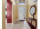 Inviting foyer featuring neutral tile floors, and a stylish wooden console table with decorative mirror at 2615 Pawnall St, Kissimmee, FL 34747