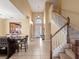 Open-concept home with a dining table, staircase, and a clear view of the front door at 2615 Pawnall St, Kissimmee, FL 34747