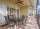 Outdoor patio with glass table and seating, ceiling fan, and screened-in pool area at 2615 Pawnall St, Kissimmee, FL 34747