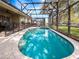 Refreshing screened pool and spa area with brick pavers; an outdoor oasis at 2615 Pawnall St, Kissimmee, FL 34747