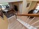 View of the interior staircase leading down to the tile flooring, featuring a dining table and lounge area at 2615 Pawnall St, Kissimmee, FL 34747