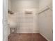 Simple walk-in closet with metal shelves and a pink carpeted floor at 2615 Pawnall St, Kissimmee, FL 34747