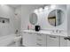 Modern bathroom with double vanity, marble countertops, and a soaking tub at 2668 Trafalgar Blvd, Kissimmee, FL 34758