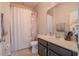 Bright bathroom with a shower/tub combo, decorative shower curtain, and vanity at 2820 Avian Loop, Kissimmee, FL 34741