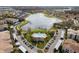 Aerial view of community featuring lake, pool, and building complex at 3001 Laurel Park Ln # 304, Kissimmee, FL 34741