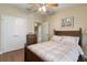 Bedroom with wooden bed frame, double doors, and ceiling fan at 3001 Laurel Park Ln # 304, Kissimmee, FL 34741