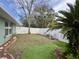 Small backyard with artificial turf and two pink chairs at 31 Augusta Cir, St Cloud, FL 34769