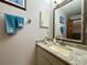 Clean bathroom with granite countertop, vanity sink, and mirrored medicine cabinet at 31 Augusta Cir, St Cloud, FL 34769