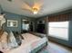 Bright bedroom with a queen-size bed, mirrored closet, and large window at 31 Augusta Cir, St Cloud, FL 34769