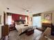 Bright bedroom with a king-size bed and wood furniture at 31 Augusta Cir, St Cloud, FL 34769