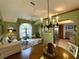 Charming dining area with chandelier and view into kitchen at 31 Augusta Cir, St Cloud, FL 34769