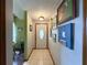 Bright entryway with light-colored tile floors and artwork at 31 Augusta Cir, St Cloud, FL 34769
