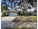 Single-story house with gray brick facade and a white garage door at 31 Augusta Cir, St Cloud, FL 34769