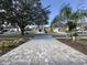 Landscaped yard with a paved driveway and mature trees at 31 Augusta Cir, St Cloud, FL 34769