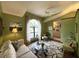 Spacious living room with green walls and a large window at 31 Augusta Cir, St Cloud, FL 34769