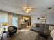 Open living room with adjacent kitchen and breakfast bar at 31 Augusta Cir, St Cloud, FL 34769