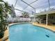 Refreshing screened-in pool with patio furniture and lush landscaping at 31 Augusta Cir, St Cloud, FL 34769