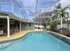 Spacious screened-in pool and patio area with a white swing at 31 Augusta Cir, St Cloud, FL 34769
