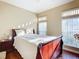 Bright bedroom with wood floors, a double bed, and large windows at 3228 Abalone Blvd, Orlando, FL 32833