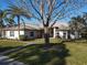 Single-story home with metal roof, landscaped lawn, and walkway at 3228 Abalone Blvd, Orlando, FL 32833