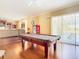 Game room with pool table and access to a lanai and pool at 3228 Abalone Blvd, Orlando, FL 32833