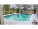 Inviting screened pool with spa and lake view at 3228 Abalone Blvd, Orlando, FL 32833