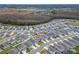 Expansive aerial view showcases the property's desirable location within a community close to scenic marshland and local amenities at 332 Pink Ibis Bnd, St Cloud, FL 34772