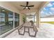 Covered patio with a fan, outdoor seating, dining table, and a view of the backyard at 332 Pink Ibis Bnd, St Cloud, FL 34772