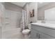 Clean bathroom with gray vanity, shower/tub combo, and gray flooring at 332 Pink Ibis Bnd, St Cloud, FL 34772