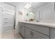 Double vanity bathroom with gray cabinets and a view of a tub at 332 Pink Ibis Bnd, St Cloud, FL 34772