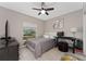 Bright bedroom with a double bed, desk, and ceiling fan at 332 Pink Ibis Bnd, St Cloud, FL 34772