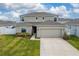Two-story house with a two-car garage and manicured lawn at 332 Pink Ibis Bnd, St Cloud, FL 34772