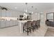 Modern kitchen with gray cabinets, stainless steel appliances, and an island at 332 Pink Ibis Bnd, St Cloud, FL 34772