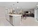 Open concept kitchen with island and adjacent living area at 332 Pink Ibis Bnd, St Cloud, FL 34772