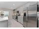 Modern kitchen featuring stainless steel appliances and gray cabinets at 332 Pink Ibis Bnd, St Cloud, FL 34772